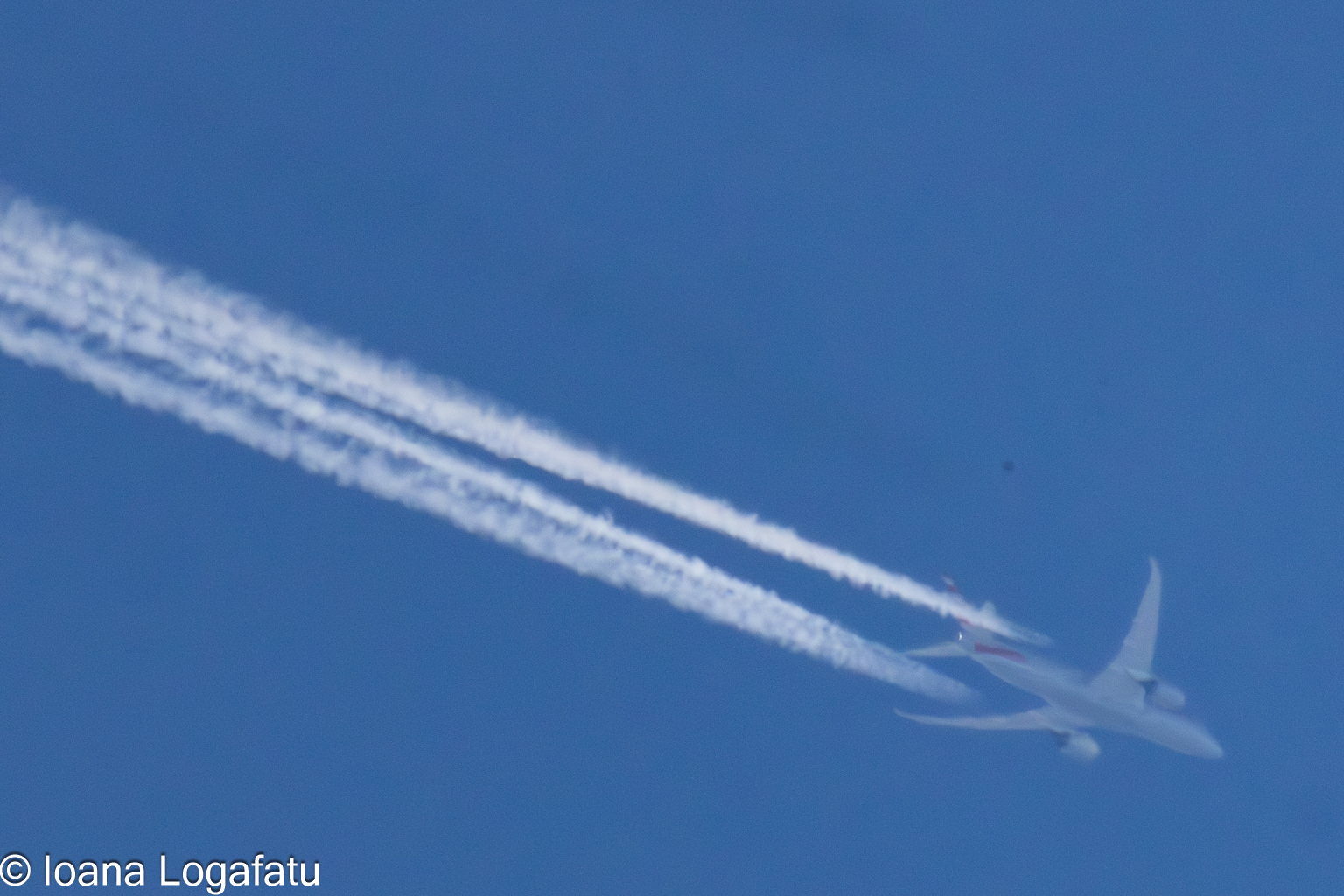 Airplane soaring through a clear blue sky